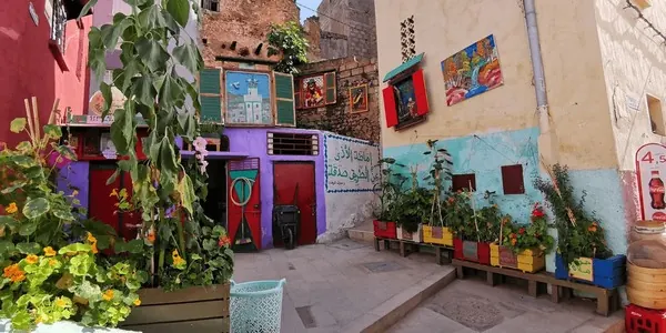Colorful painted alleyway with flower pots in the old village of Bhalil, Morocco