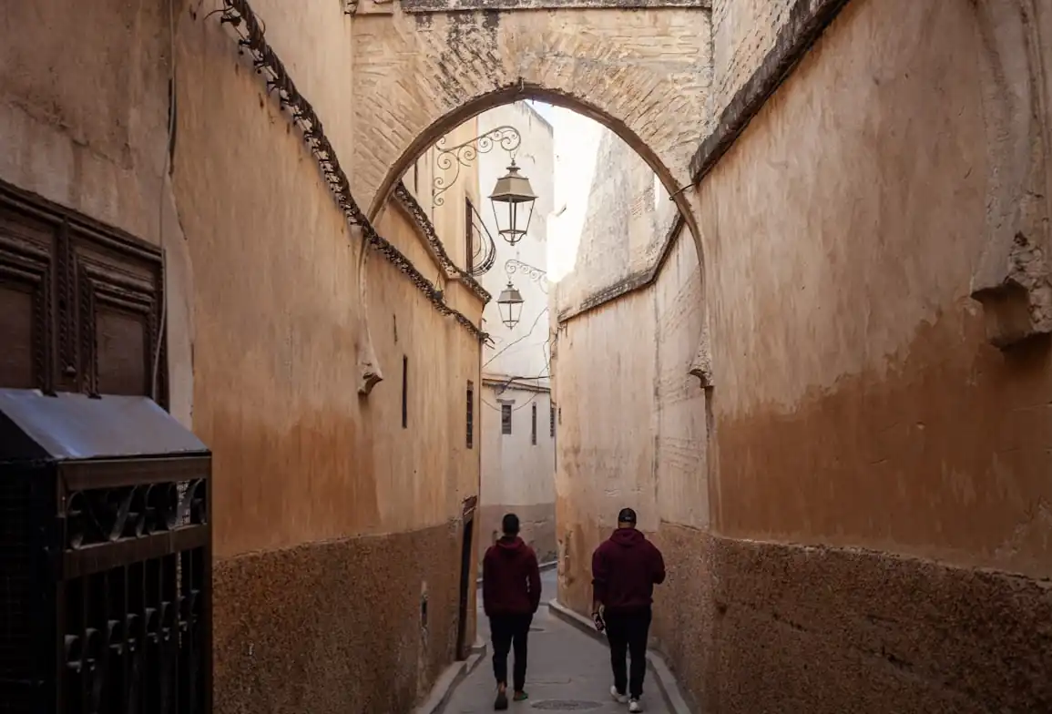 Arched alley with lanterns in the Fez medina, Morocco