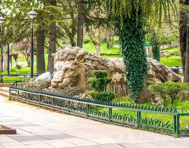 The stone lion of Ifrane surrounded by gardens, Morocco