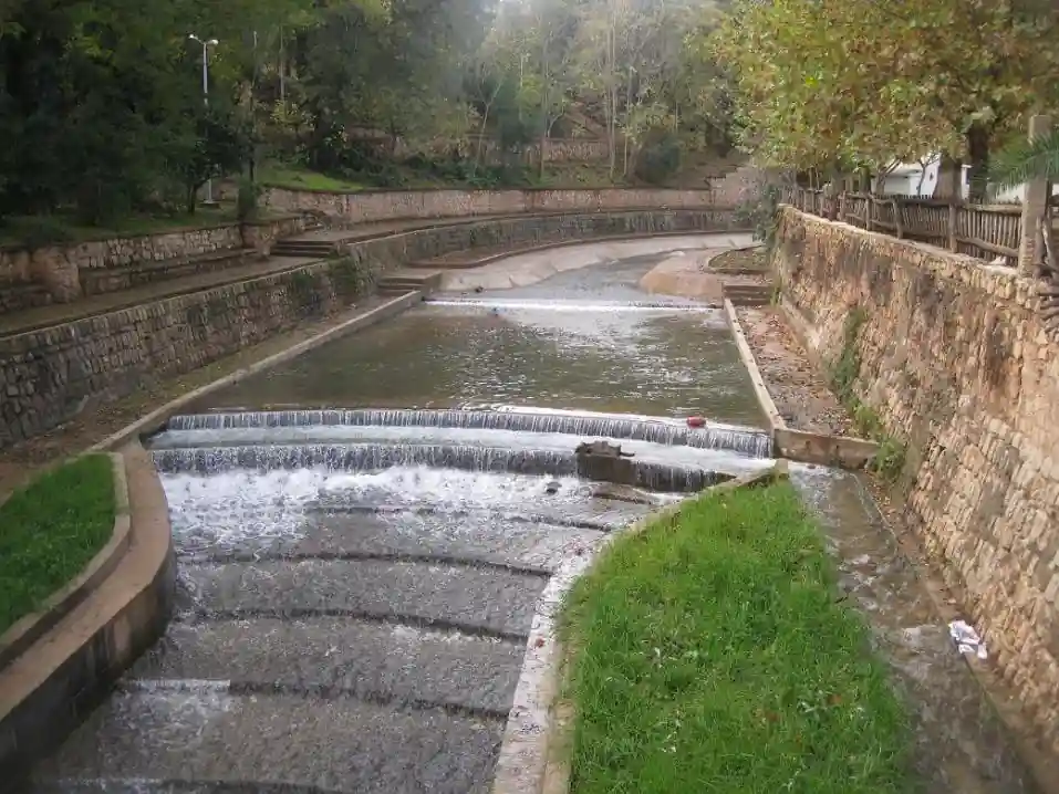 Water flowing over low stone weirs in the landscaped Oued Aggai channel