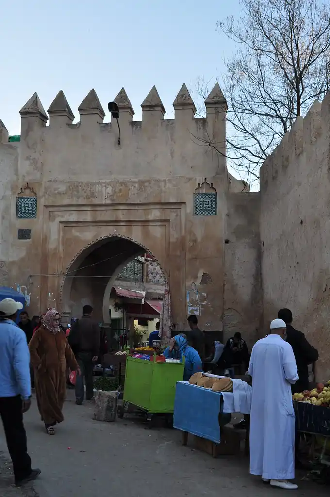 Gate in the old walls of the Sefrou medina with market stalls, Morocco