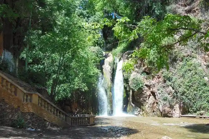 Sefrou cascade flowing into a shallow pool in a wooded gorge