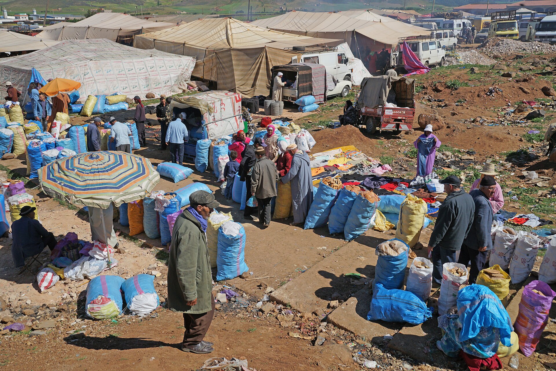 Large open weekly market with tents, traders and sacks of goods in Azrou